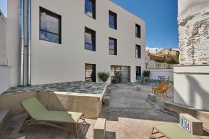 a building with a patio with chairs and tables at Hostelfly in Madrid