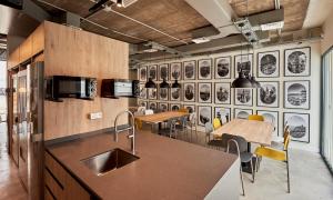 a kitchen with a sink and some tables and chairs at Hostelfly in Madrid