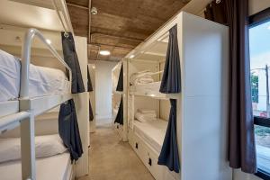 a room with bunk beds and a window at Hostelfly in Madrid +15 photos
