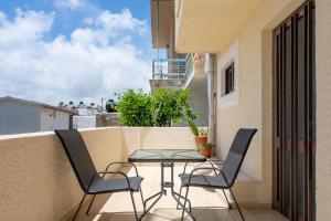a balcony with a table and chairs on a balcony at Cozy apartment in Sitia