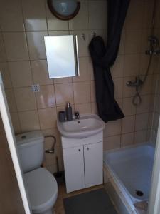 a bathroom with a toilet and a sink and a tub at Zakątek Pod Lasem in Wydminy +16 photos