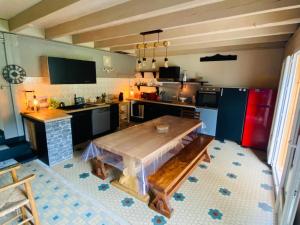 a large kitchen with a wooden table in it at Maison au pied du pic du Midi in Campan