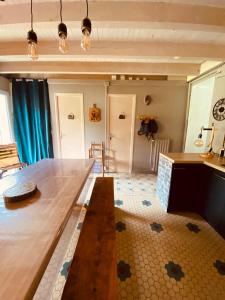 a living room with a wooden table and a floor at Maison au pied du pic du Midi in Campan