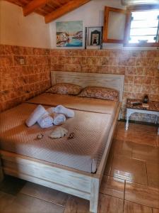 a bed in a room with towels on it at To Kyma in Skala Kallirakhis