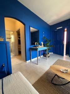 a living room with blue walls and a table at Costal apartment in Glyfada