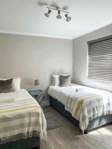 a bedroom with two beds and a window at 6 on Western Guest House in East London