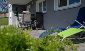 a group of chairs sitting outside of a house at Ferienwohnung Julia in Bartholomäberg