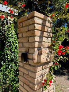 a brick wall with a bird house in a garden at Anna's cottage house in Perama