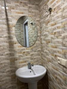 W łazience znajduje się umywalka i lustro. w obiekcie Welcome to Kobuleti w Kobuleti