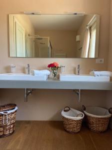 a bathroom with two sinks and a large mirror at Agriturismo B&B TorreBianca in Manduria