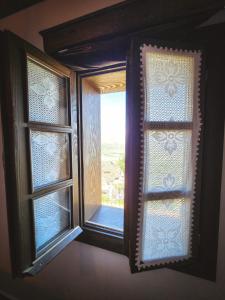 an open window in a room with a view at Bujtina Bega in Berat