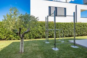 ein Basketballkorb neben einem Baum im Garten in der Unterkunft Villa Moon near the sea in Fažana