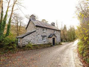 an old stone house on the side of a road at Pen y Bont in Machynlleth