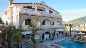 un hotel con piscina frente a un edificio en Hotel Laura, en Velipojë