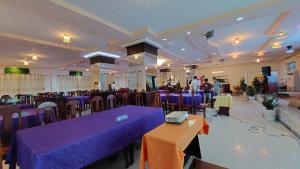 a large banquet hall with purple tables and chairs at Khách Sạn Bông Sen in Vị Thanh