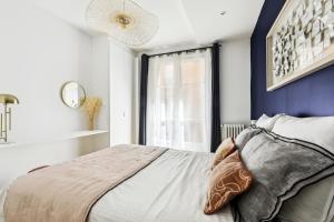 Schlafzimmer mit einem Bett und einem Fenster in der Unterkunft Dulong - Luxury near Monceau & Wagram in Paris