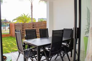 a black table and chairs on a patio at 1517 The Blyde Crystal Clear 3 Bedroom Garden Beachfront in Pretoria