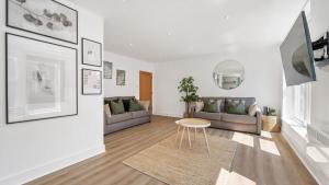 a living room with two couches and a table at Host & Stay - Lark Lane Hideaway in Liverpool