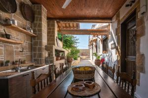 a kitchen with a table with a basket of fruit at Pool Villa Michail, in Kissamos! in Koukounará