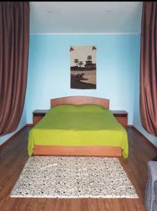 a bedroom with a bed with a rug on the floor at Иссык-Куль,Чолпон -Ата квартира in Cholpon-Ata