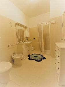 a white bathroom with a sink and a toilet at Case Pescatori Villette in Lampedusa