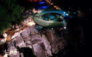an overhead view of a pool on a mountain at night at Guest House Roba in Gordi