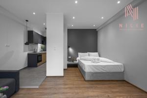 a bedroom with a bed and a kitchen at Bonsai, Nilie Hospitality MGMT in Thessaloniki