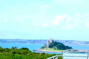 an island in the water with a castle on it at Very Spacious, Great location. Castle and Sea view in Marazion