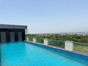 a swimming pool on the roof of a building at Regenta Dehradun by Royal Orchid Hotels Limited in Dehradun