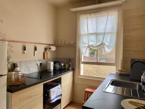 a kitchen with a sink and a stove top oven at Stylish Apt London Excel Olympic close to station in London
