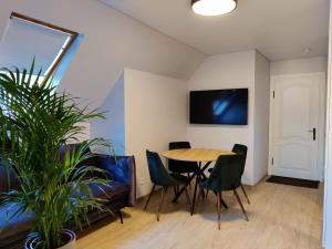 a dining room with a table and chairs at Neringos 22 in Palanga