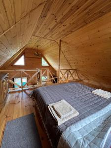 a bedroom with a bed in a wooden cabin at Veranda in Mykulychyn +79 photos