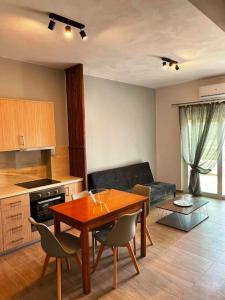 a kitchen and living room with a table and chairs at Korina's Apartment in Daratso +11 photos