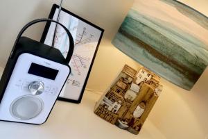 a scale sitting next to a picture of a house at Bumblebee cottage Exmouth in Exmouth