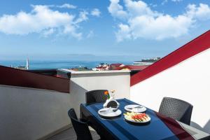 a table on a balcony with a view of the ocean at Alya Boutique Hotel in Trabzon