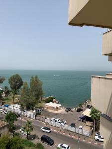 a view of a parking lot and the ocean at על שפת כנרת in Tiberias