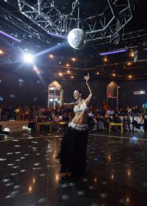 a woman dancing on a stage in front of a crowd at Djerba Holiday Beach in Midoun
