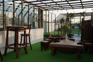 a room with wooden furniture and a table and benches at The MSUG Hotel in Tainan