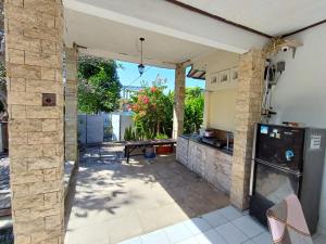 a patio with a kitchen and a table at Kanaan House in Nusa Dua