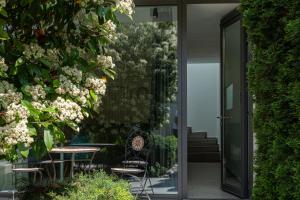 an open door to a patio with chairs and flowers at Apartamente AIFEN in Eforie Nord