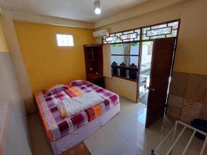 a bedroom with a bed and a large window at Kanaan House in Nusa Dua