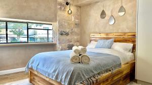 a bedroom with a bed with towels on it at Boutique apartment in heart of Haifa in Haifa