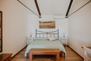 a bedroom with a bed and a table at Il Giardino del Priore Dimora Rurale in Ugento