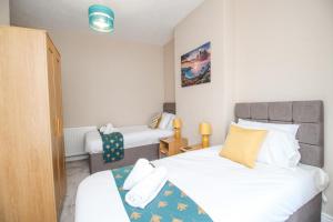 En eller flere senge i et værelse på The Skipper's House