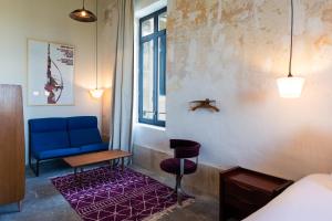 Postel nebo postele na pokoji v ubytování Hôtel La Prison