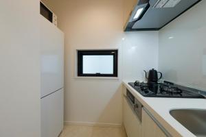 a small kitchen with a sink and a stove at Setagaya House in Tokyo