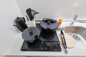 a coffee maker sitting on a counter next to a sink at Setagaya House by Tranova in Tokyo