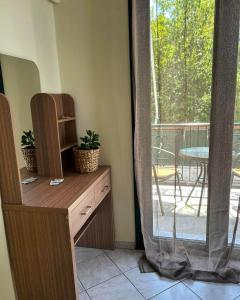 a room with a dresser and a view of a balcony at EVIA DREAM FAMILY APARTMENTS in Edipsos