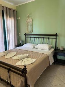 a bedroom with a large bed with two towels on it at EVIA DREAM FAMILY APARTMENTS in Edipsos