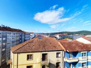 a view of roofs of buildings in a city at Mariña Home in Ourense